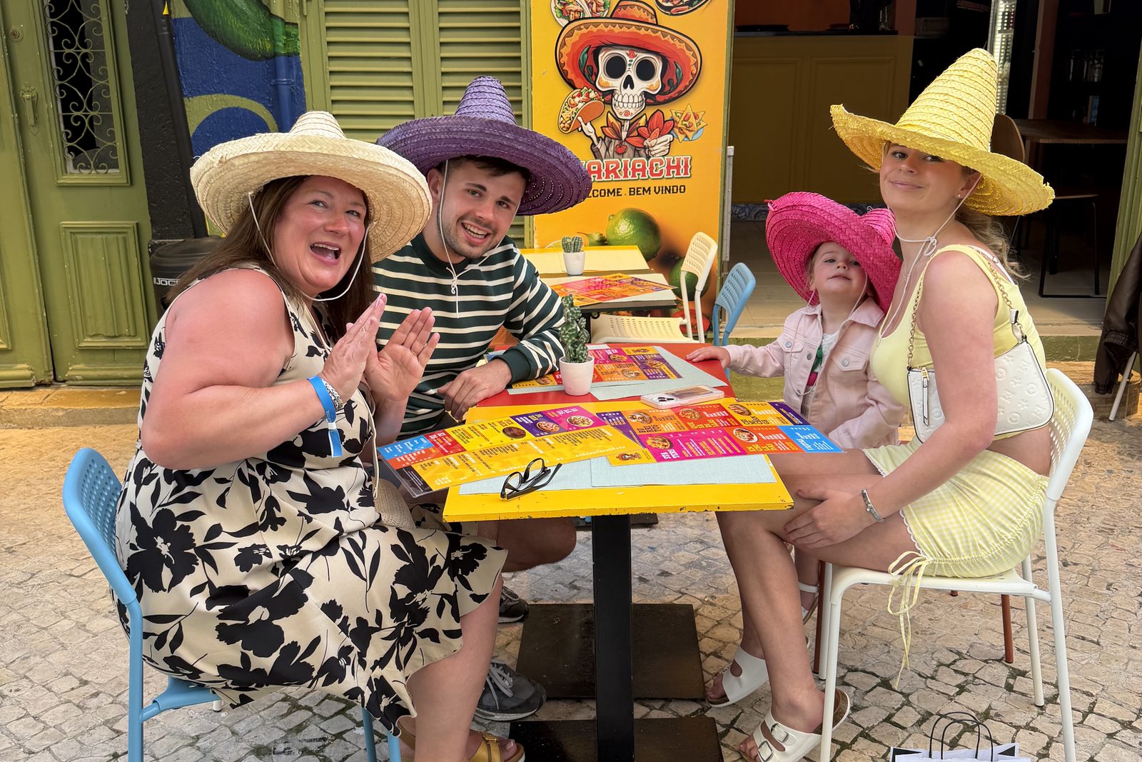 Guests reading the menu board at Mariachi's door on the cobbled Old Town street