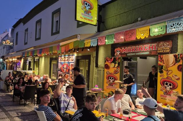 A busy evening at Mariachi with guests at tables along the cobbled street